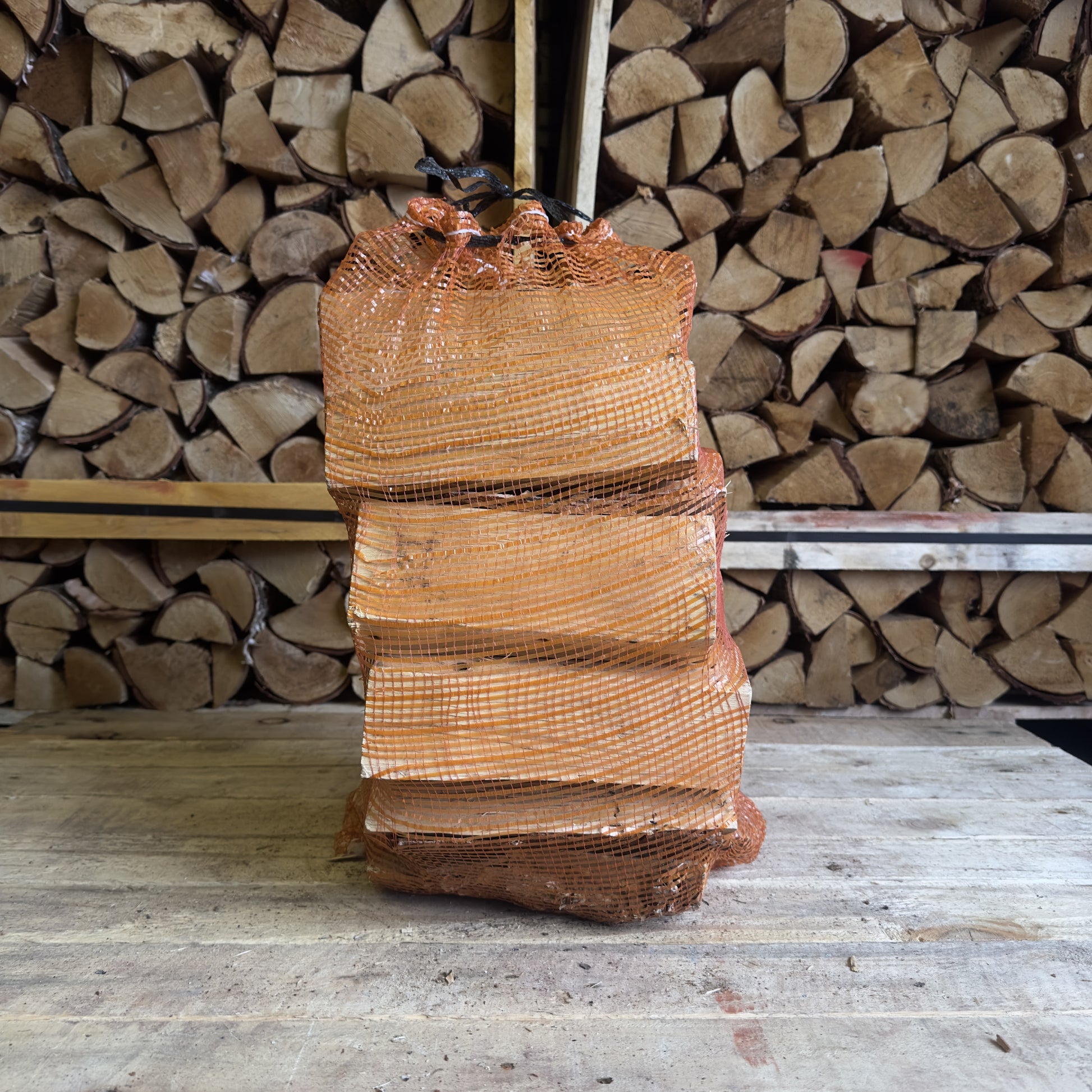 Side angle of our premium Kiln Dried Birch Logs neatly stacked in a 40L net, perfect for a long lasting fire in Leyland