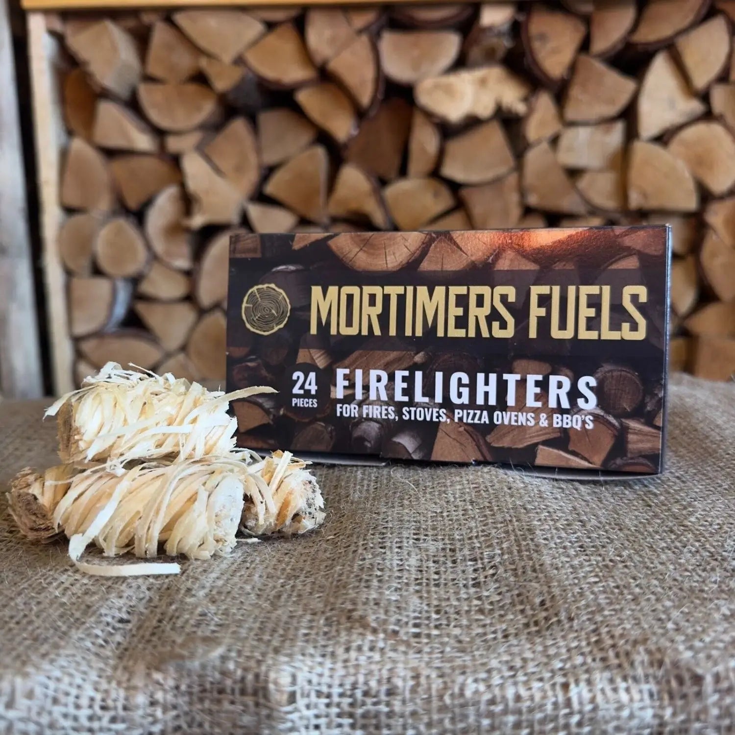 Box of Mortimer's Fuels Firelighters with firewood in the background